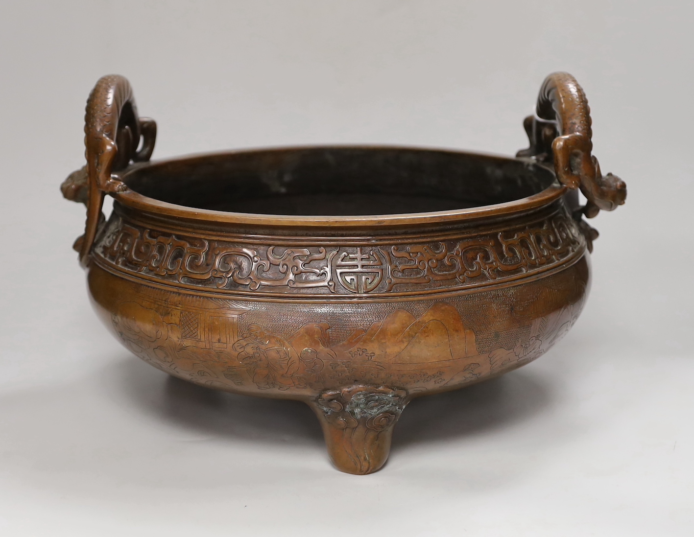 A massive Chinese brown patinated bronze ding censer, with dragon handles, 23.5cm including handles high